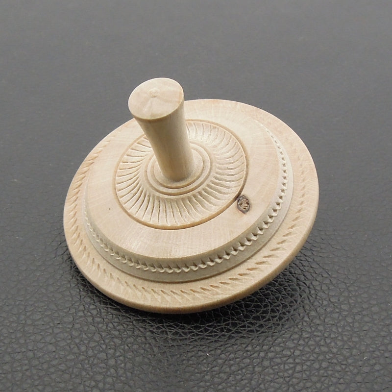 Toupie en bois de charme texturée.