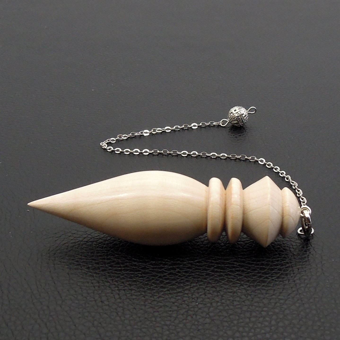 Pendule artisanal de radiesthésie en érable ondé avec chainette.