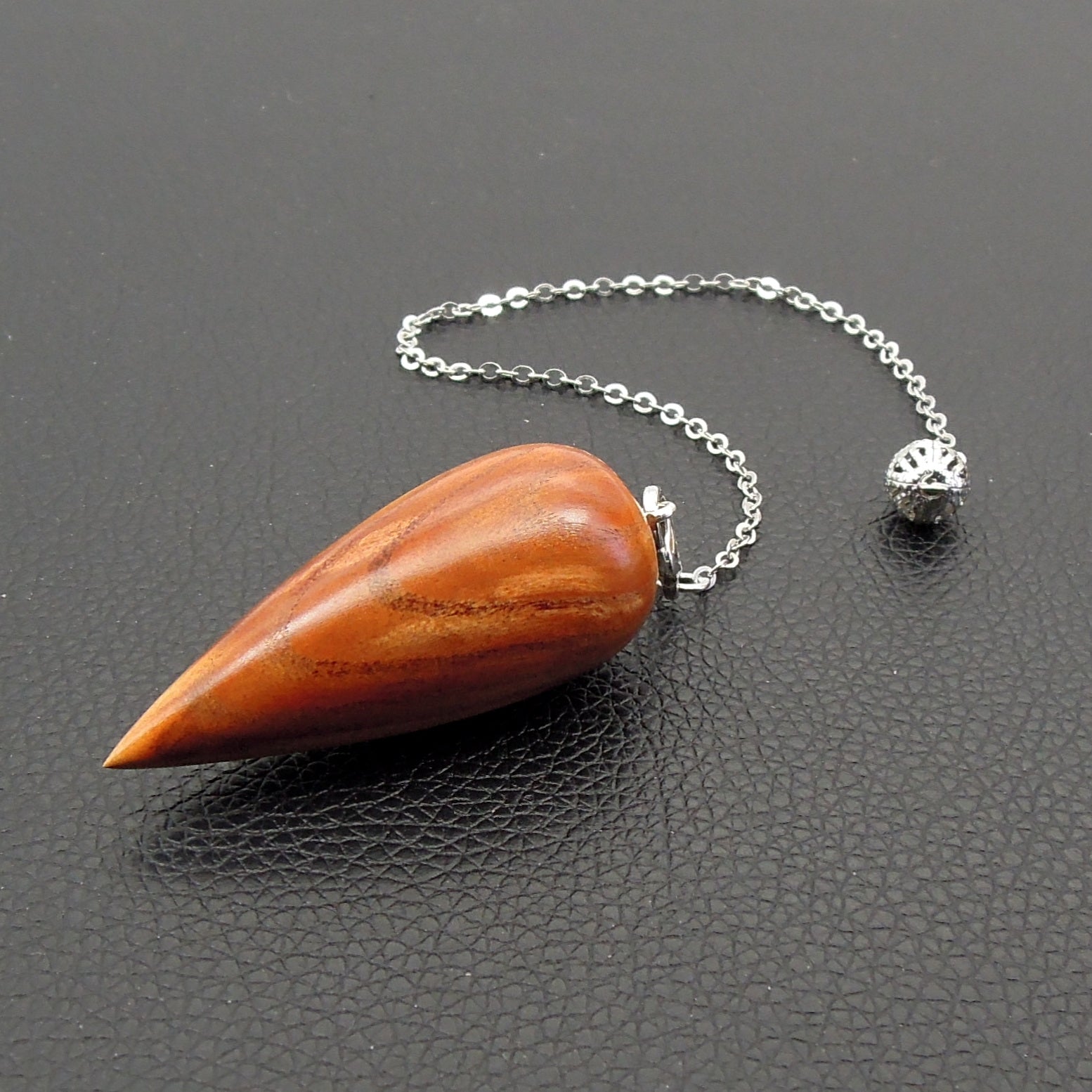 Pendule artisanal de radiesthésie en pêcher avec chainette.