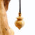 Pendule artisanal de radiesthésie en loupe de buis avec oeilleton.